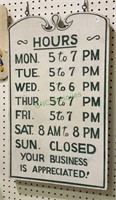 Vintage hours of operation sign on board