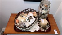 Tray of sea shells, candle
