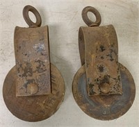 two steel and wooden pulleys