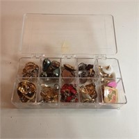 container full of earrings