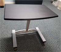 Adjustable tray table on casters.  23½×15½.