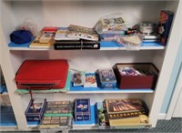 Cards and games on 3 shelves in basement.  Buyer