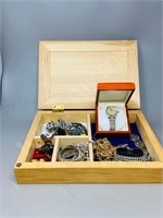 wood box full of costume jewelry and a watch