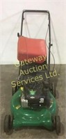 Weed eater lawnmower with gas jug.