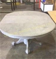 Wooden oval kitchen table has been painted grey..