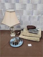 Modern lamp, wall art plate, and towels