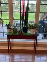 Red refinished distressed console table & plants