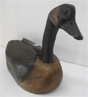 Wood goose with glass eyes. Measures 12" H x 19"
