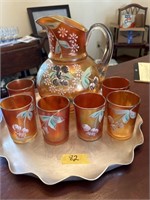 Carnival glass painted pitcher and cup set