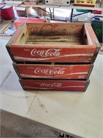 Three Coca-Cola crates