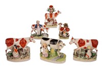 GROUP OF SIX STAFFORDSHIRE POTTERY COW FIGURES