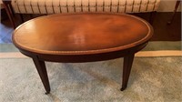 Vintage mahogany oval coffee table, with brown