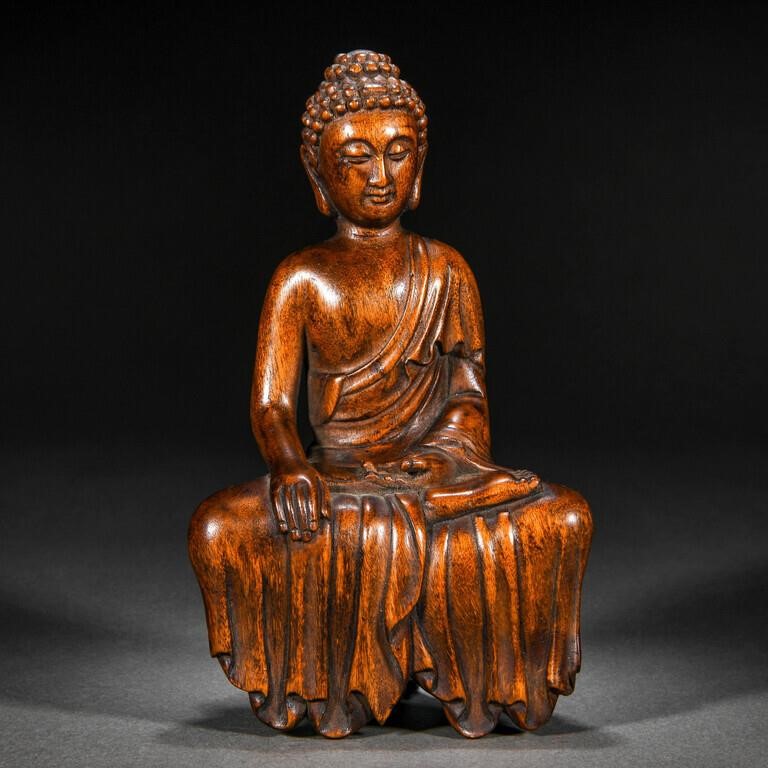A Chinese Carved Aloes Wood Seated Buddha