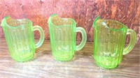 3 green plastic pitchers