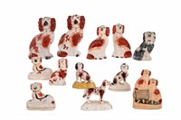 GROUP OF STAFFORDSHIRE POTTERY SPANIEL FIGURES