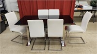 Glass table top and 6 white leather chairs.