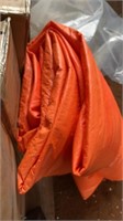 AN ORANGE, INSULATED TARP, SOME HOLES IN THIS,