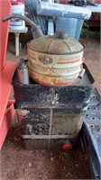 AN EARLY FUEL CAN, A VINTAGE FUEL TANK, AND OIL