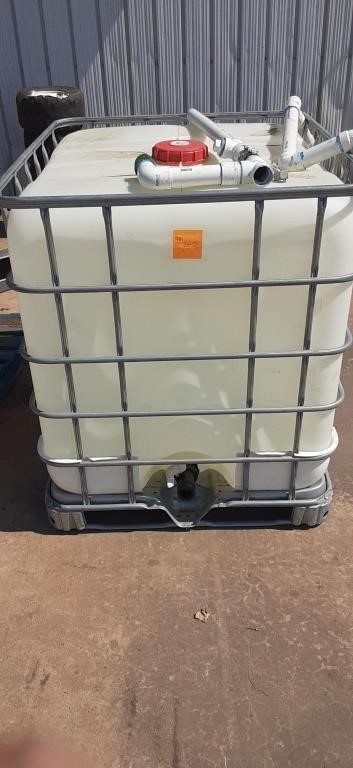 Portable water container with skids on the bottom