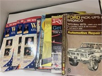 Stack of Automotive Repair, Workd Atlas, and
