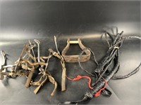 Box with a stirrup, several horse bits, bull whip