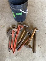 pail of Pipe wrenches and hammers