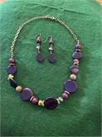 Gold necklace with purple stones and gold ball