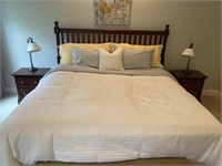 California king bed with wooden headboard