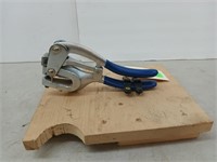 Industrial hole punch mounted on a piece of wood