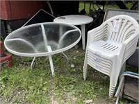 1 - Glass Top Outdoor Table & 7 - Plastic Chairs