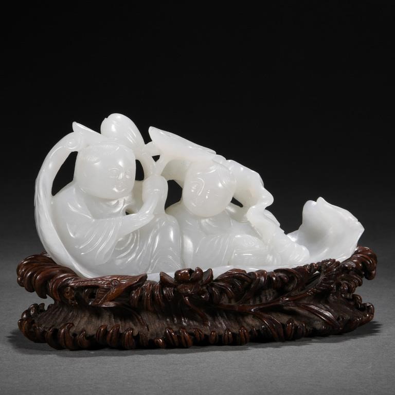 A CHINESE CARVED WHITE JADE BOAT