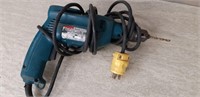 Makita 8450 Electric Hand Drill with bit working