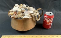 Brass pot full of seashells and agates