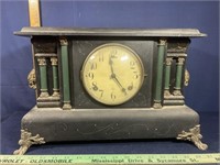 Black wooden cased mantle clock with green