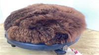 Buffalo fur covered foot rest, 16 in across, 7 in