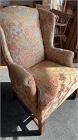Wingback upholstered chair with peacock design in