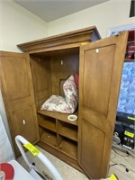 Wooden two door entertainment center with contents