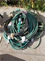 Assorted hoses and metal half drum