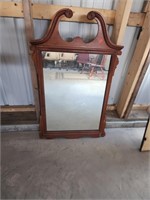 Older mirror with ornate wooden frame