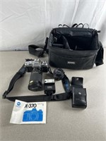 Vintage Minolta X-370 camera with accessories and