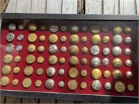 Railroad Buttons in Display Case.
