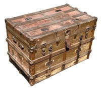 Ribbed flat top steamer trunk showing assorted