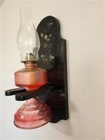 Antique Indiana pink glass oil lamp with oil.