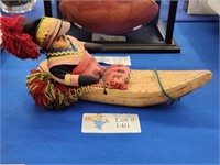 COLORFUL HANDMADE CARVING OF FIGURE IN CANOE