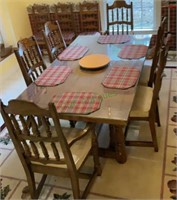 Larger sized dining room table with six chairs.
