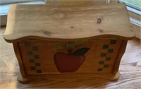 Wooden bread box with apple motif measures