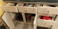 Contents of lower left of stove cabinets -