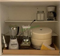 Contents of cabinet - blender, coffee maker,