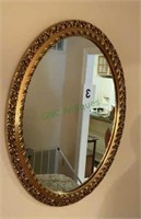 Oval gold gilded mirror measuring 33 inches