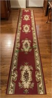 Beautiful long runner rug with burgundy coloring.